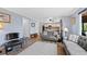 Bright living room with hardwood floors and a view into kitchen provides a spacious living space at 10512 Hyacinth St, Highlands Ranch, CO 80129