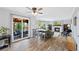 Open-concept living room featuring wood-look floors, sliding glass doors to the patio, a fireplace, and comfortable seating at 10512 Hyacinth St, Highlands Ranch, CO 80129