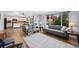 Open-concept living area with hardwood floors and modern sofas offers comfortable seating at 10512 Hyacinth St, Highlands Ranch, CO 80129