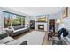 Bright living room with large window, fireplace, and hardwood floors is perfect for relaxation at 10512 Hyacinth St, Highlands Ranch, CO 80129
