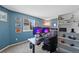 Bright home office features a large window and a wall of shelving at 10512 Hyacinth St, Highlands Ranch, CO 80129