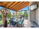 Outdoor patio with stylish dining set, covered roof with string lights, and a heater for comfortable outdoor dining at 10512 Hyacinth St, Highlands Ranch, CO 80129