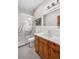 Modern bathroom with glass shower, wood vanity, and tiled floors at 19 South Rd, Breckenridge, CO 80424