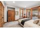 Comfortable bedroom featuring a large wardrobe, neutral tones, and wood trim windows at 19 South Rd, Breckenridge, CO 80424