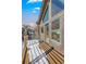 Exterior view of the deck showcases wood floors and natural light through large windows at 19 South Rd, Breckenridge, CO 80424