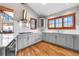 Open kitchen features light cabinets, stainless steel appliances, and hardwood floors at 19 South Rd, Breckenridge, CO 80424