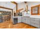 Open concept kitchen with stainless steel appliances, wooden beams, and bar seating at 19 South Rd, Breckenridge, CO 80424
