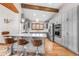 Bright kitchen with stainless steel appliances, quartz countertops, and hardwood floors at 19 South Rd, Breckenridge, CO 80424