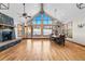 Bright living room featuring vaulted ceilings, stone fireplace, hardwood floors, and large windows at 19 South Rd, Breckenridge, CO 80424