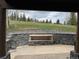 Covered outdoor patio with a built in fire pit and views of the surrounding landscape at 19 South Rd, Breckenridge, CO 80424