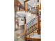 Staircase with wooden steps, navy railing, wooden beams, and stone tile flooring at 19 South Rd, Breckenridge, CO 80424