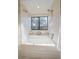 Clean bathroom with a bathtub and shower, and a window at 4401 S Lincoln St, Englewood, CO 80113