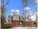 Brick house with a fenced yard and mature trees at 4401 S Lincoln St, Englewood, CO 80113