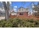 Brick home with dormer windows, attached garage, and a wooden fence at 4401 S Lincoln St, Englewood, CO 80113