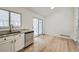 Bright kitchen features stainless steel dishwasher, granite countertops, and sliding glass doors to the back patio at 19132 E 22Nd Pl, Aurora, CO 80011