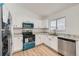 Modern kitchen featuring white cabinets, granite countertops, and stainless steel appliances at 19132 E 22Nd Pl, Aurora, CO 80011