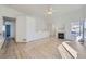 Bright living room with vaulted ceiling, hardwood floors, a fireplace, and an open floor plan at 19132 E 22Nd Pl, Aurora, CO 80011