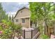 View of back deck with awning surrounded by mature landscaping and roses at 13424 W 64Th Pl, Arvada, CO 80004
