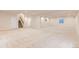 Expansive finished basement with neutral carpet, recessed lighting, and a staircase, providing ample living or recreational space at 13424 W 64Th Pl, Arvada, CO 80004