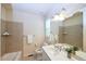 Bright bathroom featuring a vanity, toilet, mirror, and tiled shower-tub combo at 13424 W 64Th Pl, Arvada, CO 80004