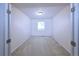 Empty bedroom with neutral carpet, one window and simple light fixture at 13424 W 64Th Pl, Arvada, CO 80004