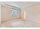 Large bedroom with carpeted floors, tray ceiling, and a bright window at 13424 W 64Th Pl, Arvada, CO 80004