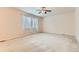 Large bedroom with two large windows offering natural light and neutral carpet at 13424 W 64Th Pl, Arvada, CO 80004