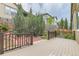 Outdoor deck area with landscaping, privacy fence, and neighbor's houses in the background at 13424 W 64Th Pl, Arvada, CO 80004