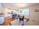 Eat-in kitchen area boasts a modern chandelier, wood floors, and adjacent view to the kitchen at 13424 W 64Th Pl, Arvada, CO 80004