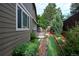 Exterior shot of home with small deck, garden area, and privacy fence at 13424 W 64Th Pl, Arvada, CO 80004