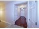 Entryway hallway with hardwood floors, white trim, and doors leading to other rooms at 13424 W 64Th Pl, Arvada, CO 80004
