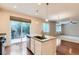 Contemporary kitchen with a center island, stainless steel appliances, and hardwood floors at 13424 W 64Th Pl, Arvada, CO 80004