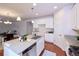 Modern kitchen with granite counters, stainless steel appliances, white cabinets, and an island with a sink at 13424 W 64Th Pl, Arvada, CO 80004