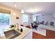 Open concept kitchen and living area with hardwood floors and an island with bar seating at 13424 W 64Th Pl, Arvada, CO 80004