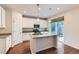 Bright kitchen with granite counters, stainless steel appliances, and a view to the back deck at 13424 W 64Th Pl, Arvada, CO 80004