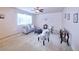 Spacious living room features a cozy sofa, stylish chairs, and a ceiling fan at 13424 W 64Th Pl, Arvada, CO 80004