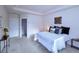 Comfortable main bedroom features a bed, closet, and tray ceiling at 13424 W 64Th Pl, Arvada, CO 80004