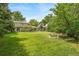 Spacious backyard showcasing mature trees, manicured lawn, and the home's exterior with a serene outdoor ambiance at 2276 S Dover Way, Lakewood, CO 80227