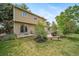 Charming backyard featuring a patio, landscaped garden beds, and a well-maintained lawn at 2276 S Dover Way, Lakewood, CO 80227
