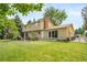 Spacious backyard with a lawn, patio, ideal for outdoor dining and relaxation at 2276 S Dover Way, Lakewood, CO 80227