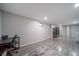 Open basement area with space for multiple uses and modern gray flooring and ample lighting at 2276 S Dover Way, Lakewood, CO 80227