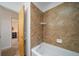 Bathroom featuring tile shower with built-in shelving, and updated hardware at 2276 S Dover Way, Lakewood, CO 80227