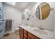 Bathroom featuring double sinks, custom lighting, and a separate toilet area at 2276 S Dover Way, Lakewood, CO 80227