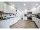 Beautiful kitchen featuring stainless steel appliances, granite counters, and updated cabinets and lighting at 2276 S Dover Way, Lakewood, CO 80227