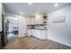 Bright white kitchen with stainless steel appliances and modern flooring with eat in breakfast area at 2276 S Dover Way, Lakewood, CO 80227