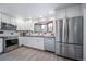 Renovated kitchen features stainless appliances, granite counters, white shaker cabinets, and breakfast nook at 2276 S Dover Way, Lakewood, CO 80227