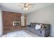 Relaxing living room boasts a brick fireplace, cozy sofa, and neutral decor at 2276 S Dover Way, Lakewood, CO 80227