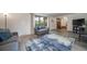 Spacious living room features wood-look flooring, stylish furnishings, and ample natural light at 2276 S Dover Way, Lakewood, CO 80227