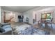 Open-concept living space showcasing wood-look floors, access to the dining area, and a staircase at 2276 S Dover Way, Lakewood, CO 80227