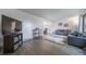 Bright living room with wood-look floors, neutral paint, and modern furnishings at 2276 S Dover Way, Lakewood, CO 80227